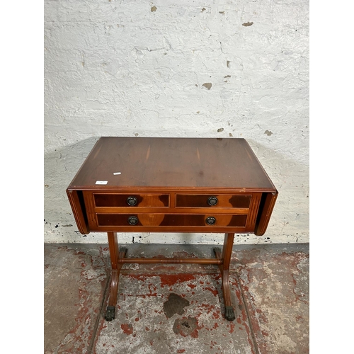 43 - A Regency style yew wood drop leaf three drawer sofa table with brass lion paw feet and lower stretc... 