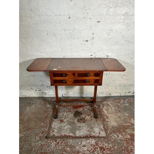 43 - A Regency style yew wood drop leaf three drawer sofa table with brass lion paw feet and lower stretc... 