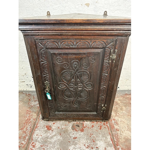 49 - A Georgian carved oak wall mountable corner cabinet - approx. 94cm high x 79cm wide x 41cm deep