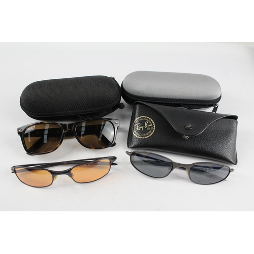 2171 - Three pairs of cased sunglasses, one Ray-Ban and two Oakley