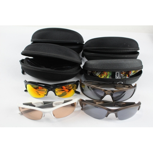 2173 - Four pairs of cased Oakley sunglasses