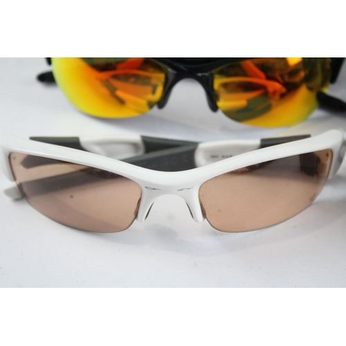 2173 - Four pairs of cased Oakley sunglasses