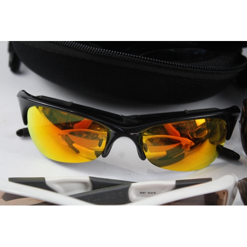 2173 - Four pairs of cased Oakley sunglasses