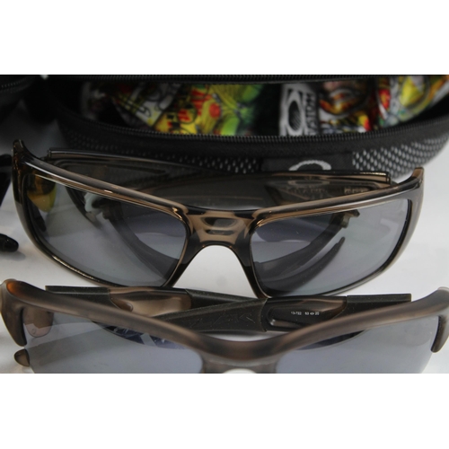 2173 - Four pairs of cased Oakley sunglasses