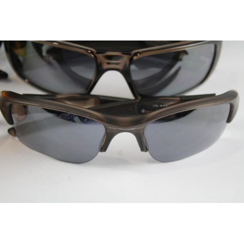 2173 - Four pairs of cased Oakley sunglasses