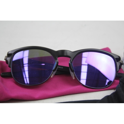 2179 - Four pairs of cased Oakley sunglasses