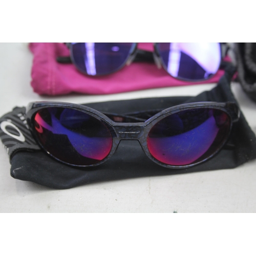 2179 - Four pairs of cased Oakley sunglasses