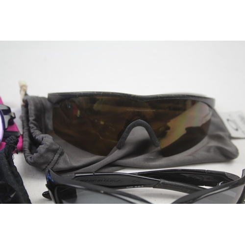 2179 - Four pairs of cased Oakley sunglasses