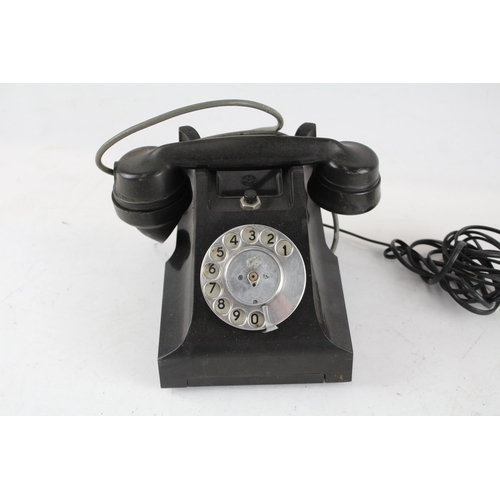 551 - A vintage bakelite rotary telephone