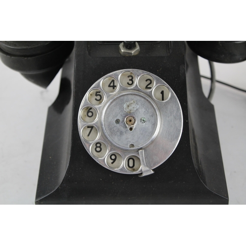 551 - A vintage bakelite rotary telephone