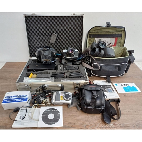 610 - A collection of cameras and accessories to include cased Minolta X-300 35mm SLR camera with instruct... 