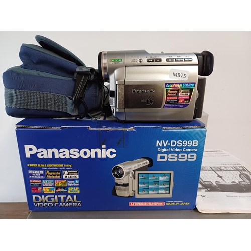 615 - A collection of items to include boxed and cased Panasonic NV-DS99B Mini DV camcorder with accessori... 