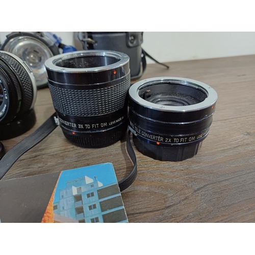 618 - A collection of items to include Olympus OM-System Zuiko 1:4 f=75mm auto-zoom and 1:1.8 50mm lenses,... 
