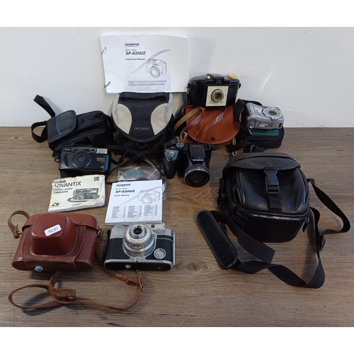 620 - Five cased cameras to include Olympus Stylus SP-820UZ digital with instruction manual and software d... 