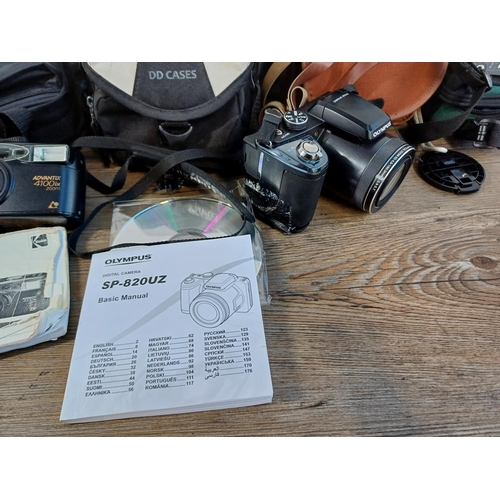 620 - Five cased cameras to include Olympus Stylus SP-820UZ digital with instruction manual and software d... 