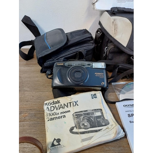 620 - Five cased cameras to include Olympus Stylus SP-820UZ digital with instruction manual and software d... 