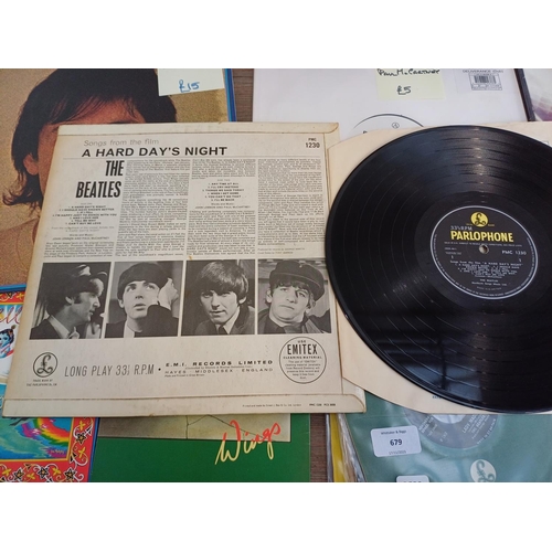 679 - A collection of The Beatles and related vinyl records to include 'A Hard Day's Night' (mono), 'Lady ... 