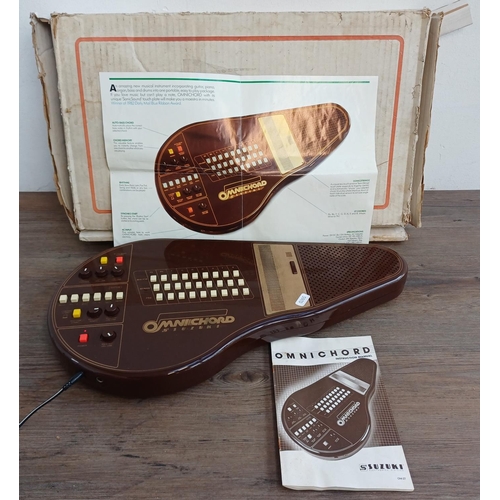 690 - A boxed early 1980s Suzuki Omnichord OM-27 electronic musical instrument with power adaptor and inst... 