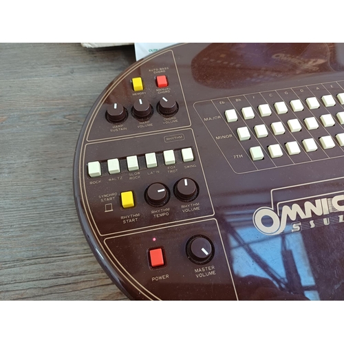 690 - A boxed early 1980s Suzuki Omnichord OM-27 electronic musical instrument with power adaptor and inst... 