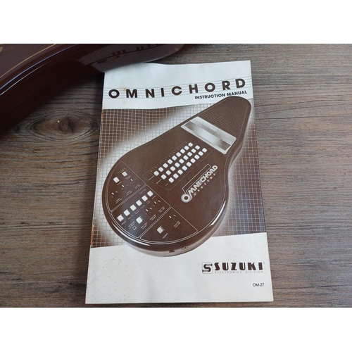 690 - A boxed early 1980s Suzuki Omnichord OM-27 electronic musical instrument with power adaptor and inst... 