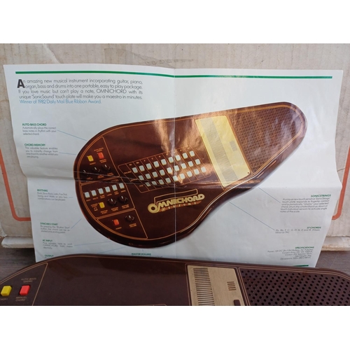 690 - A boxed early 1980s Suzuki Omnichord OM-27 electronic musical instrument with power adaptor and inst... 