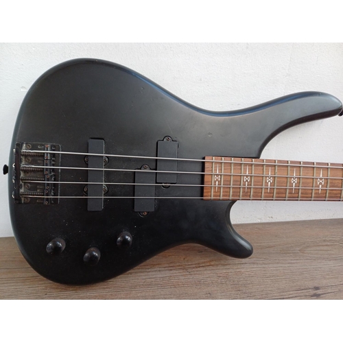 691 - A Stagg matt black four-string electric bass guitar