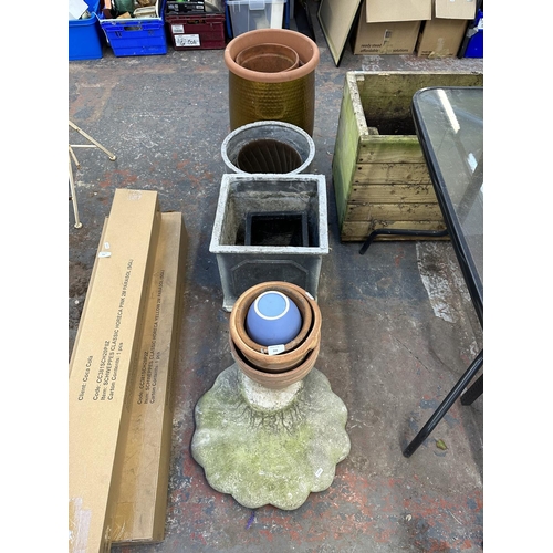 844 - A collection of garden items to include terracotta planters, cast stone bird bath base etc.