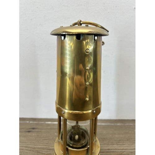 509 - An early 20th century E. Thomas & Williams Ltd brass miners lamp - approx. 25cm high