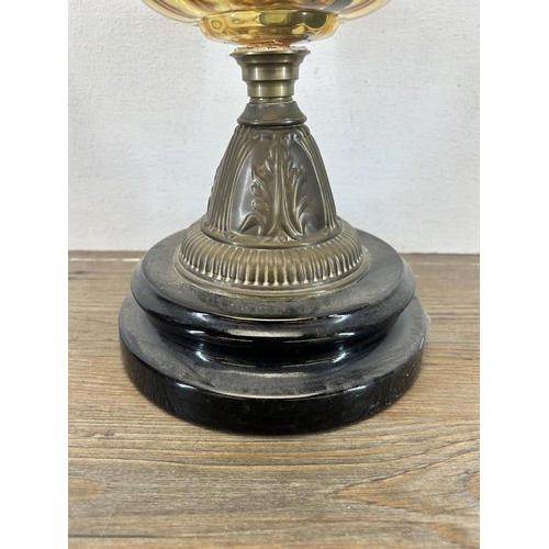 517 - A Victorian Falk's brass oil lamp with amber glass reservoir and ebonized base - approx. 31cm high