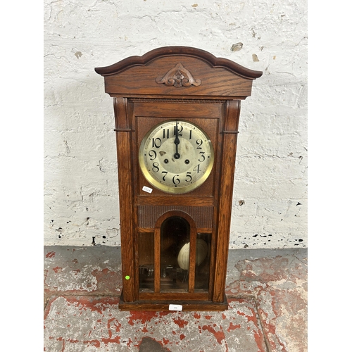 548 - A 1940s oak cased chiming wall clock