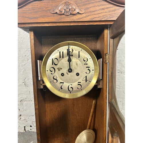 548 - A 1940s oak cased chiming wall clock