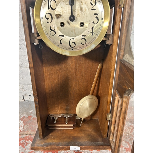 548 - A 1940s oak cased chiming wall clock