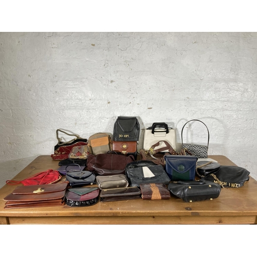 489 - A large collection of assorted handbags