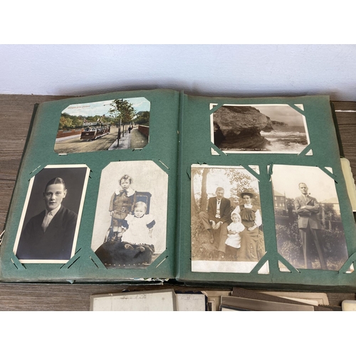 491 - A collection of Victorian and later photographs and postcards