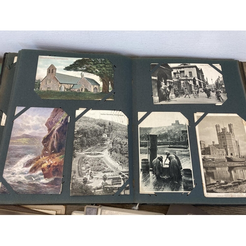 491 - A collection of Victorian and later photographs and postcards