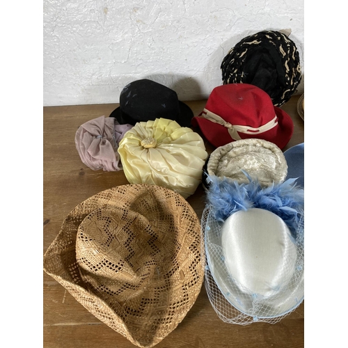 501 - A large collection of vintage hats to include early to mid 20th century black felt bowler hat, fur h... 