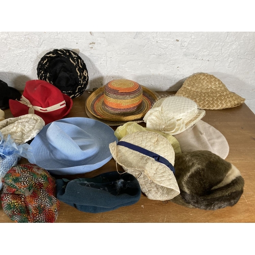 501 - A large collection of vintage hats to include early to mid 20th century black felt bowler hat, fur h... 