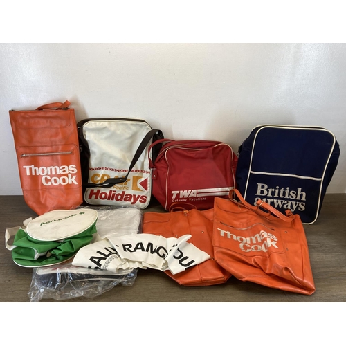 502 - A collection of vintage flight bags to include Thomas Cook, British Airways etc.