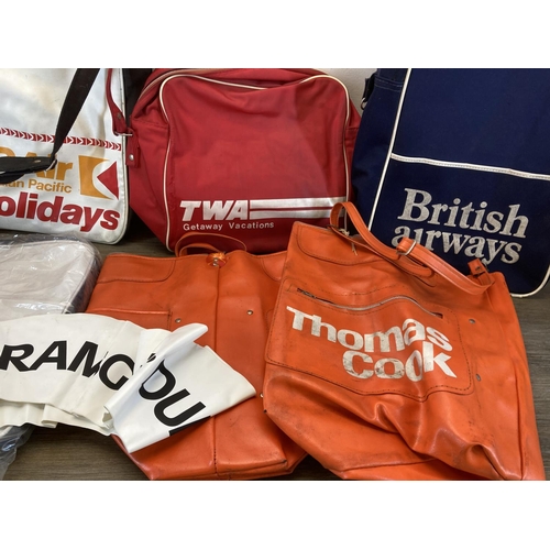 502 - A collection of vintage flight bags to include Thomas Cook, British Airways etc.