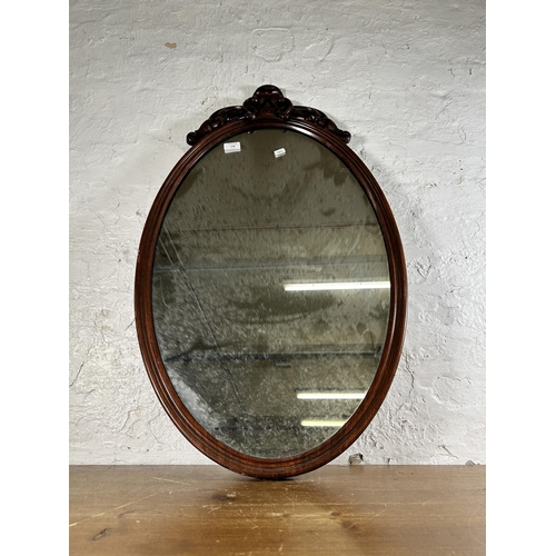 238 - A late 19th century carved mahogany framed oval wall mirror - approx. 92cm high x 55cm wide