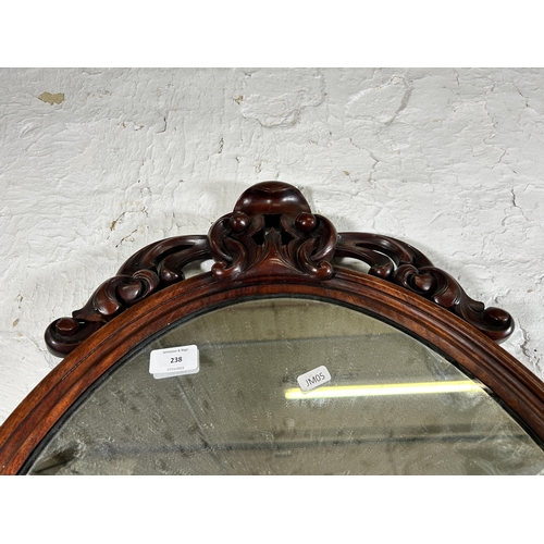 238 - A late 19th century carved mahogany framed oval wall mirror - approx. 92cm high x 55cm wide