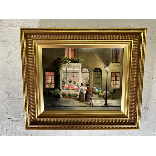 239A - A gilt framed Deborah Jones (1921-2012) oil on board of a 19th century shop front scene - approx. 45... 