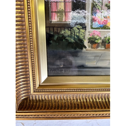 239A - A gilt framed Deborah Jones (1921-2012) oil on board of a 19th century shop front scene - approx. 45... 