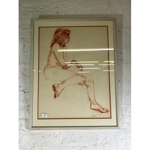 240 - A late 20th century framed red pastel portrait of a nude female signed Carl and dated 1988 - approx.... 