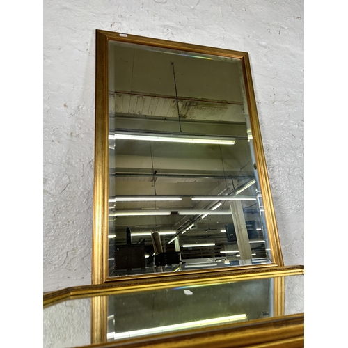 243 - Two gilt framed wall mirrors - largest approx. 84cm high x 58cm wide