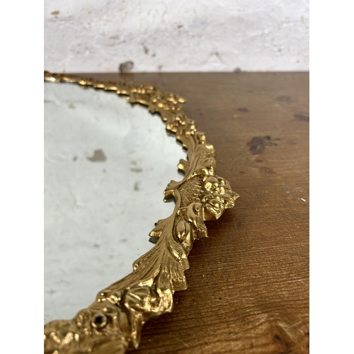 252 - A 20th century gilt metal framed wall mirror with bow design - approx. 56cm high x 47cm wide