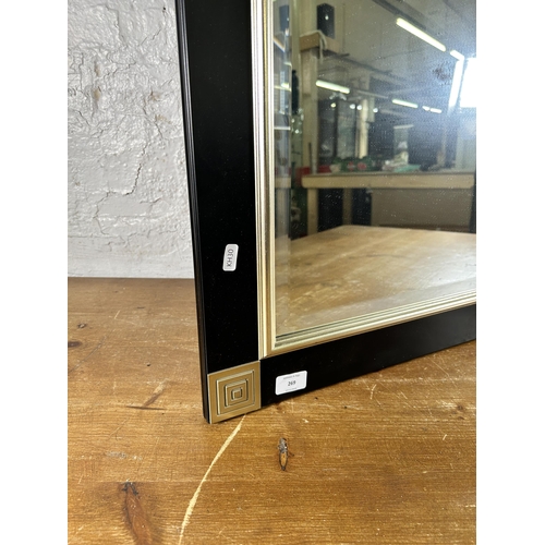 269 - A modern black and silver painted framed bevelled edge wall mirror - approx. 75cm high x 106cm wide