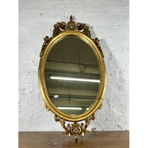 276 - A Rococo style gilt framed oval wall mirror - approx. 100cm high x 50cm wide