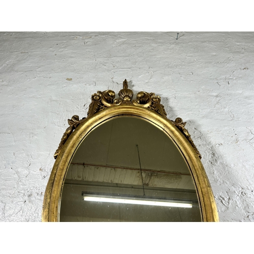 276 - A Rococo style gilt framed oval wall mirror - approx. 100cm high x 50cm wide