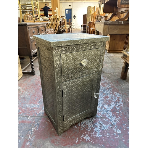 124 - A Middle Eastern embossed metal bedside cabinet - approx. 66cm high x 40cm wide x 30cm deep
